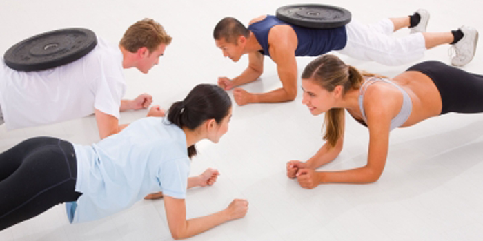 Group exercise class doing bodyweight exercise