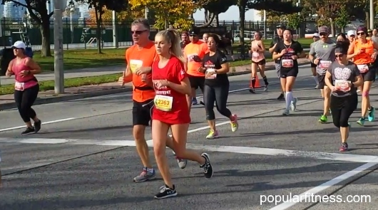 A couple running a marathon together - photo by popular fitness