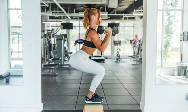 Woman exercising with weights at the gym