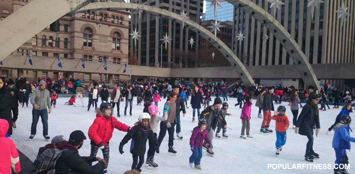 Ice skating in winter in the city - downtown Toronto City Hall skating rink