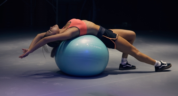 Woman exercising using an exercise ball