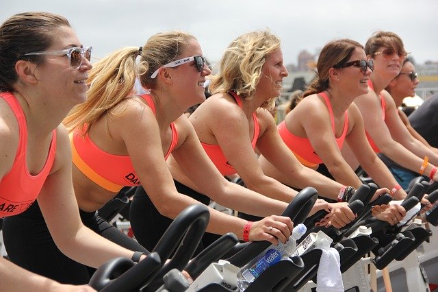 Group of women cycling on exercise bikes