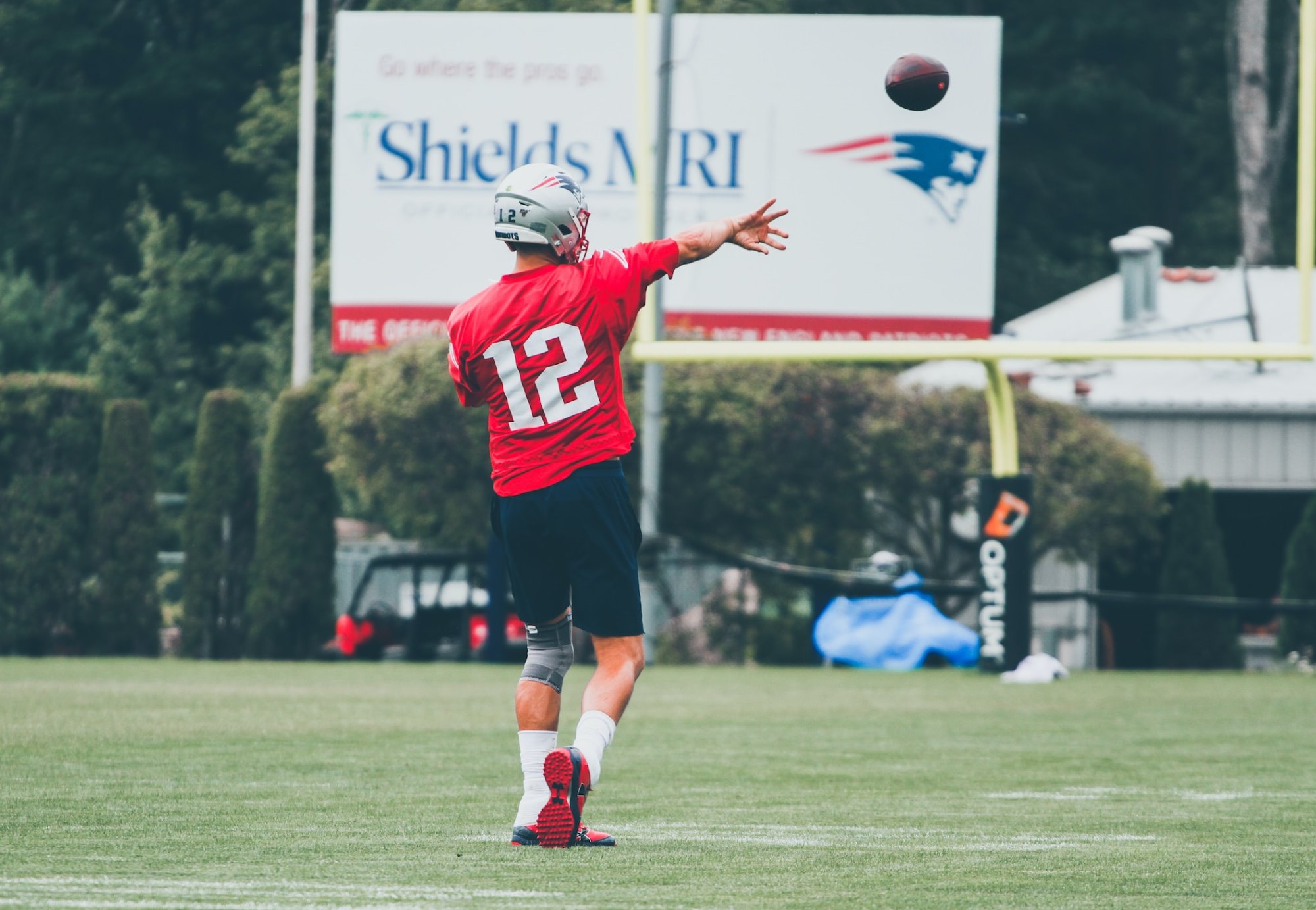 NFL quarterback Tom Brady throwing a pass during a New England Patriot practice.
