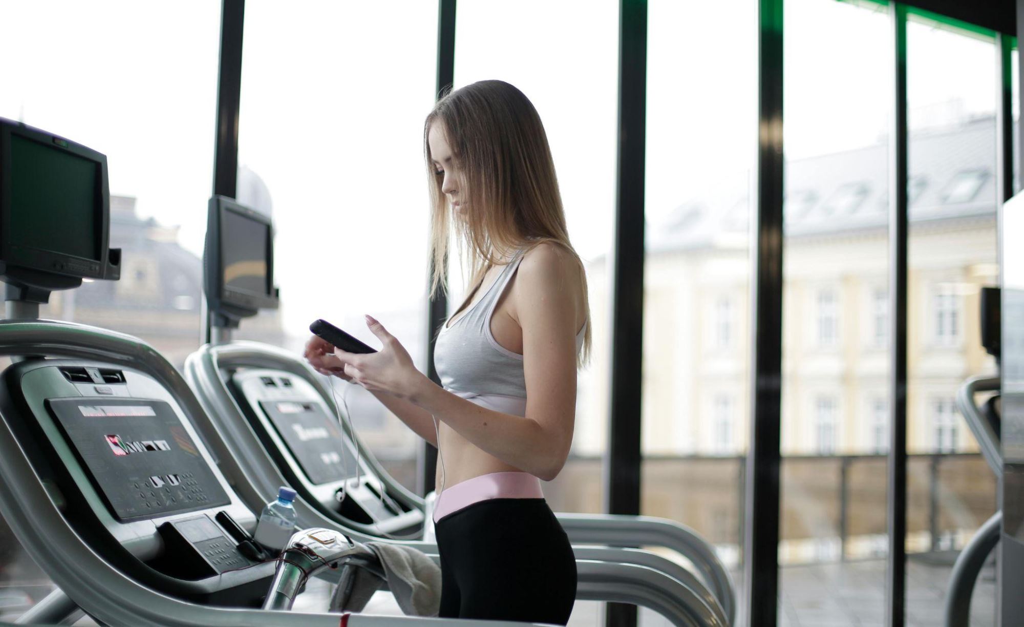 A woman doing a cardio exercise workout at the gym on a treadmill.
