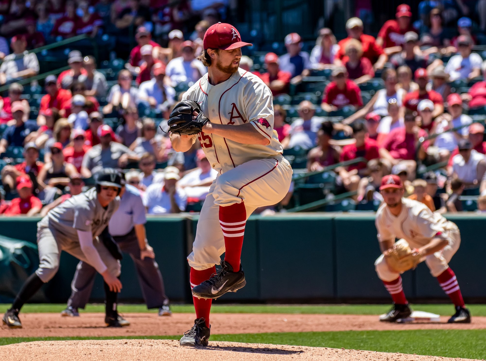 A professional baseball pitcher throwing a pitch during a baseball game.