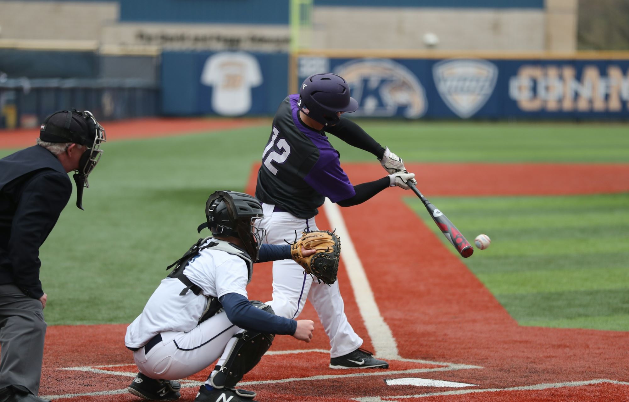 Baseball player swinging a bat during a baseball game.