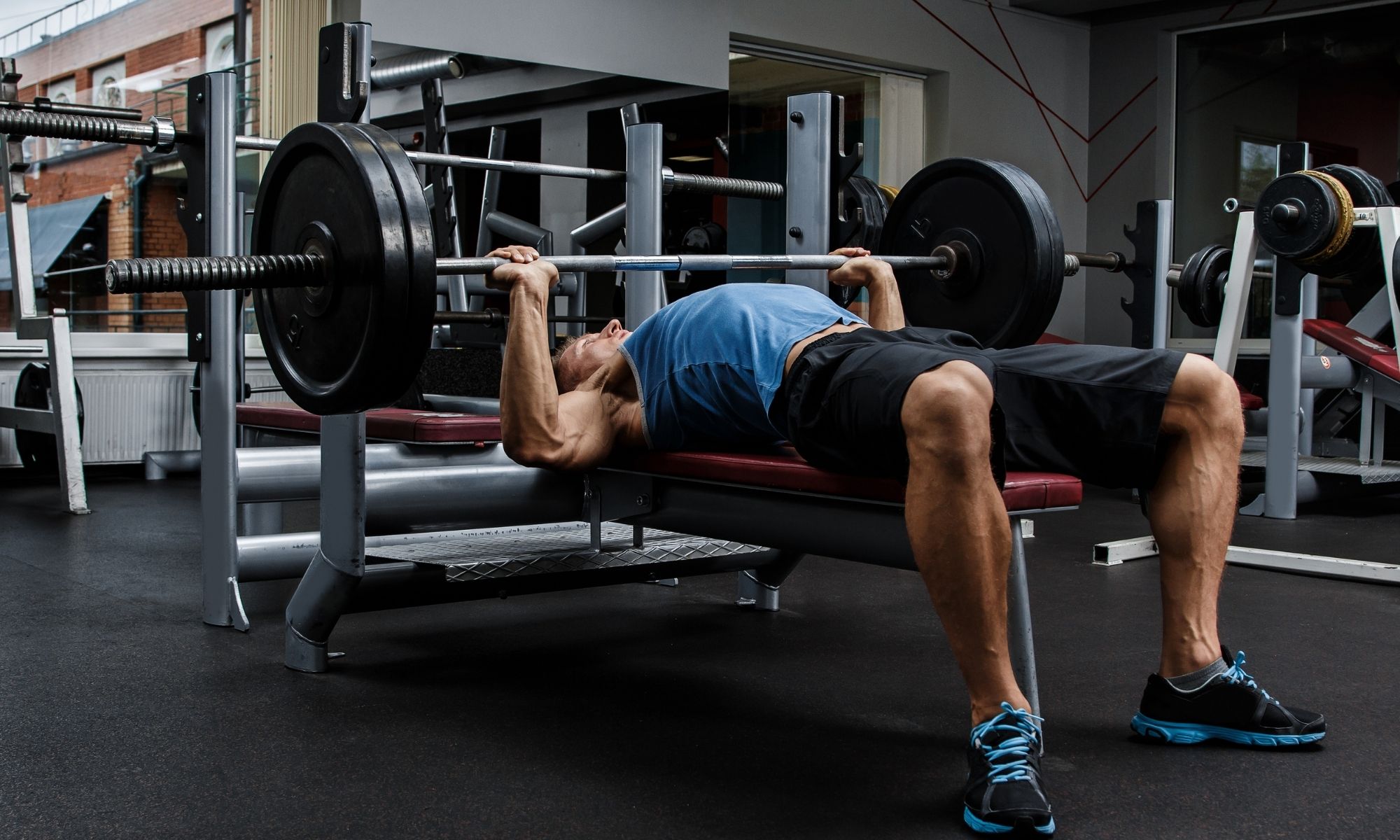 Man doing the chest bench press exercise at the gym.