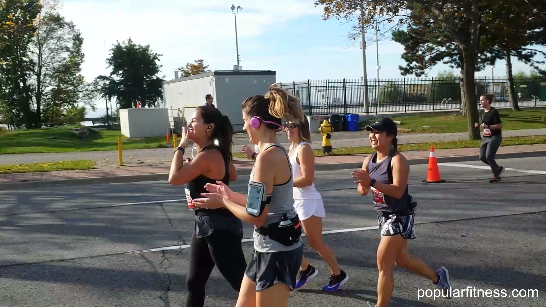 blowing a kiss close-up at marathon - photo by popular fitness