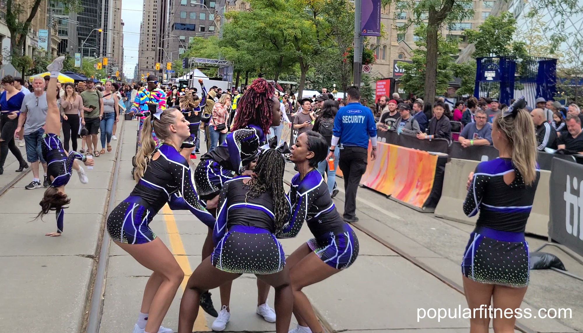 Cheerleaders lifting a cheerleader to complete their cheerleading routine