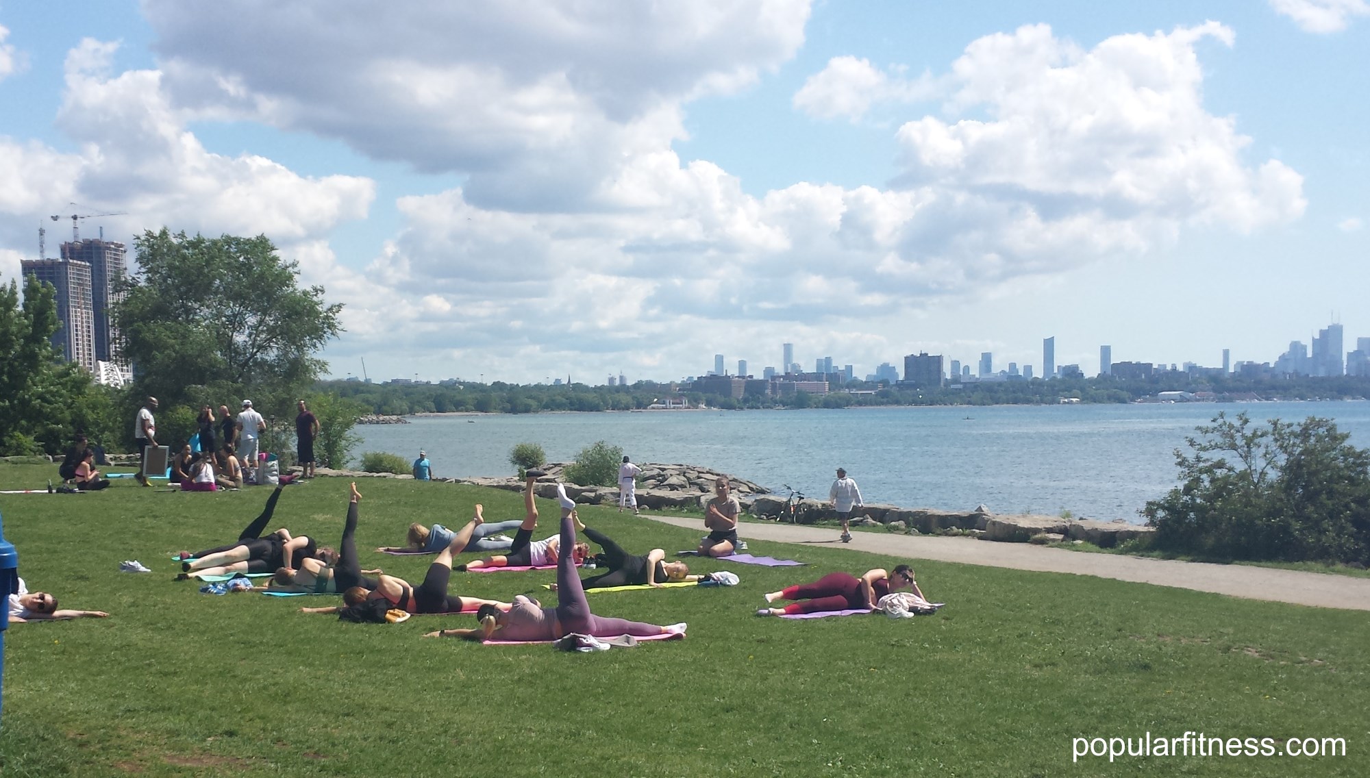 Group of women exercising outdoors by Lake Ontario in Toronto - Photo by popular fitness