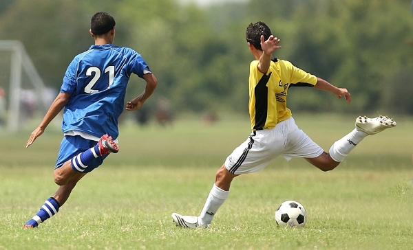 To men playing the game of soccer