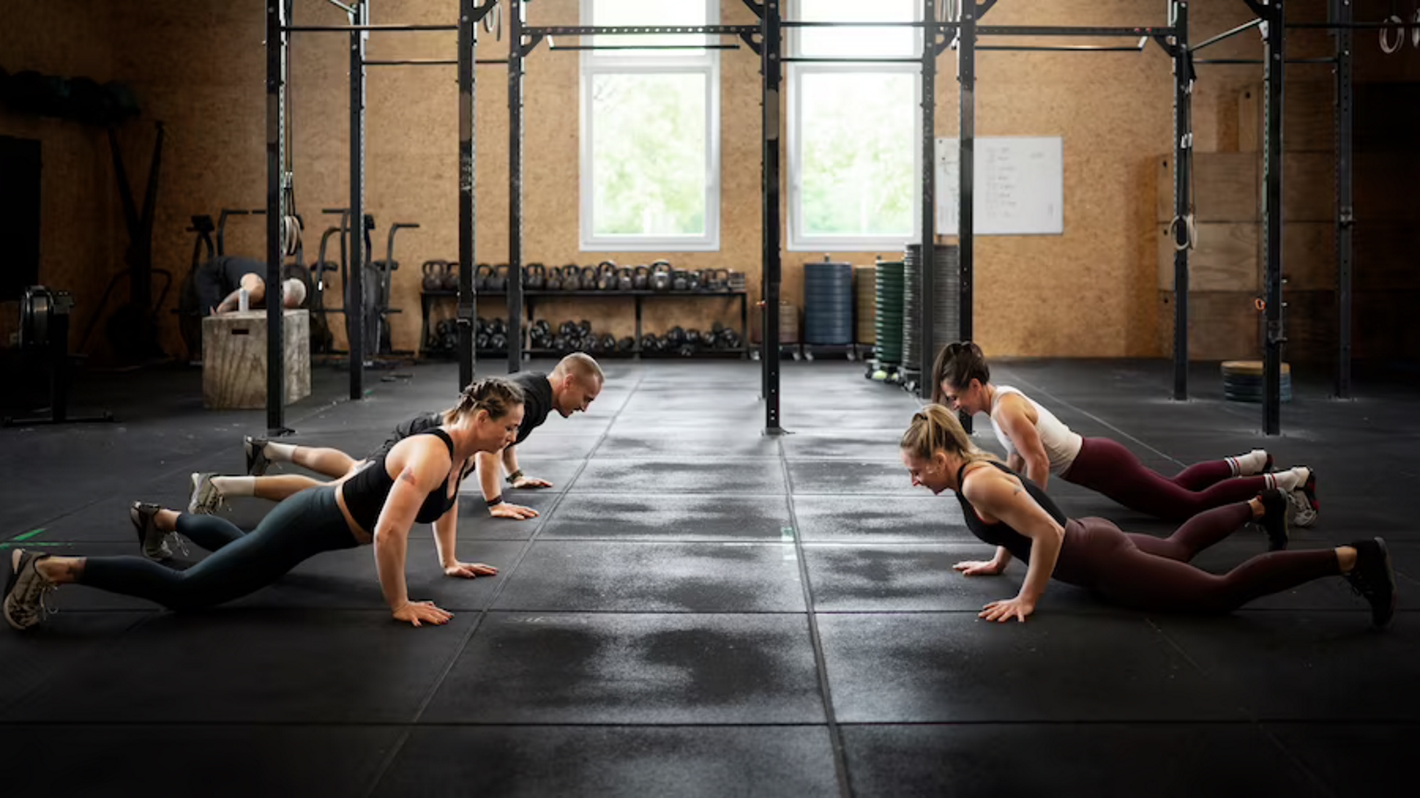 Group doing bodyweight exercise - burpees