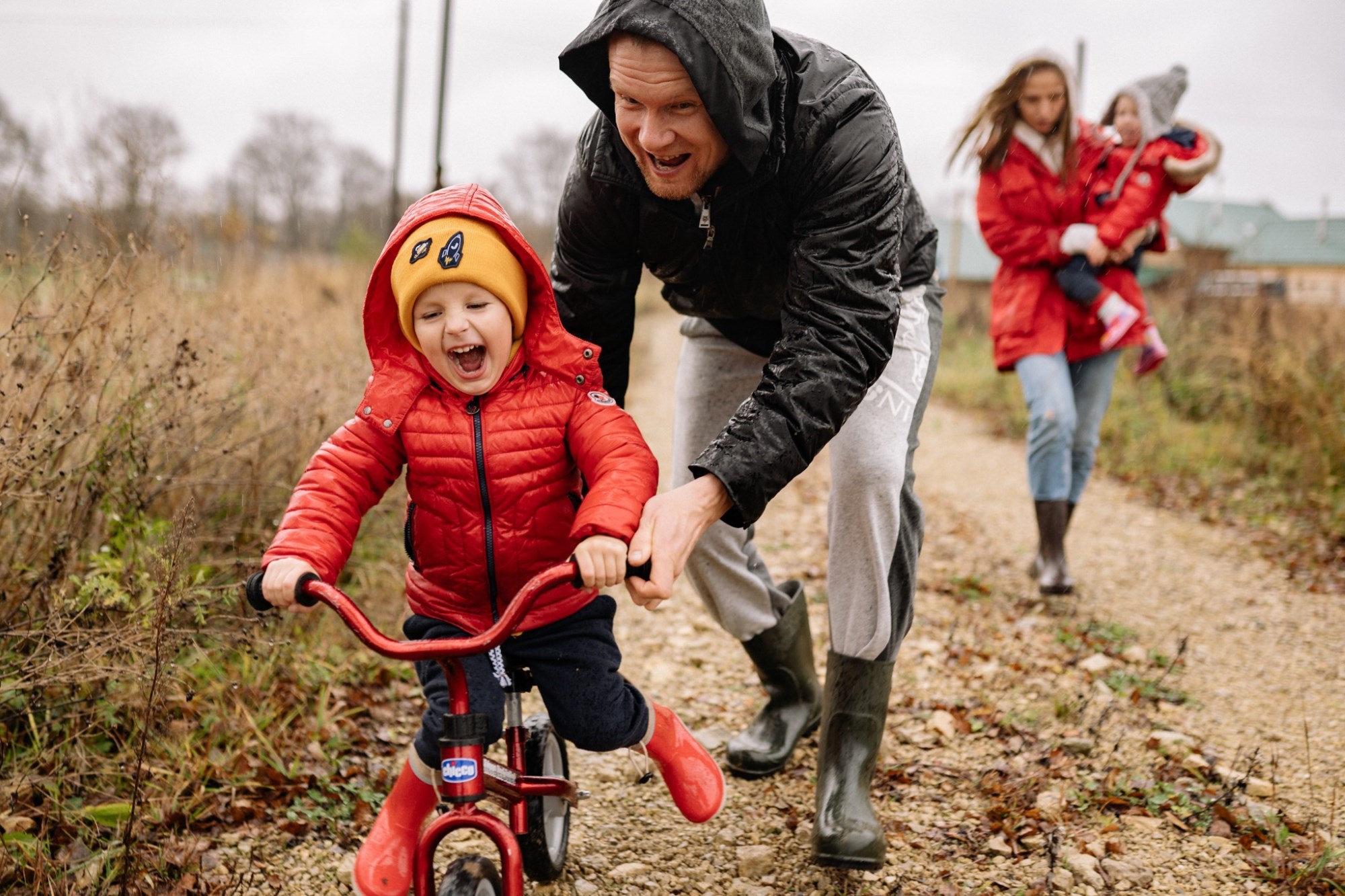 Dad helping and teaching his son to ride a bike