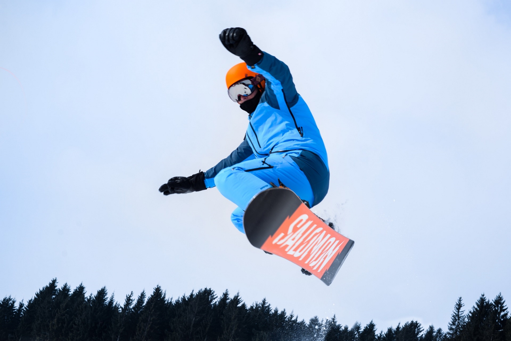 Man on the slopes enjoying sport of snowboarding using a Salomon snowboard