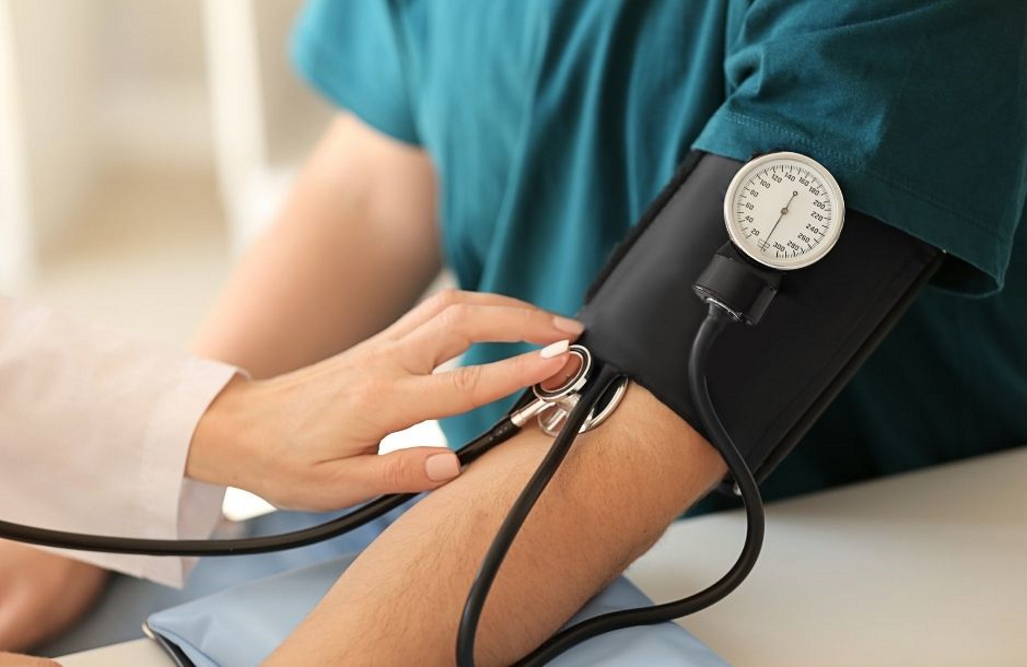 Patient having blood pressure taken by a nurse