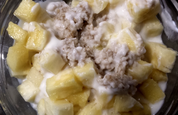 Oats with milk, plain white yogurt, pineapple for a healthy breakfast - Photo by popular fitness