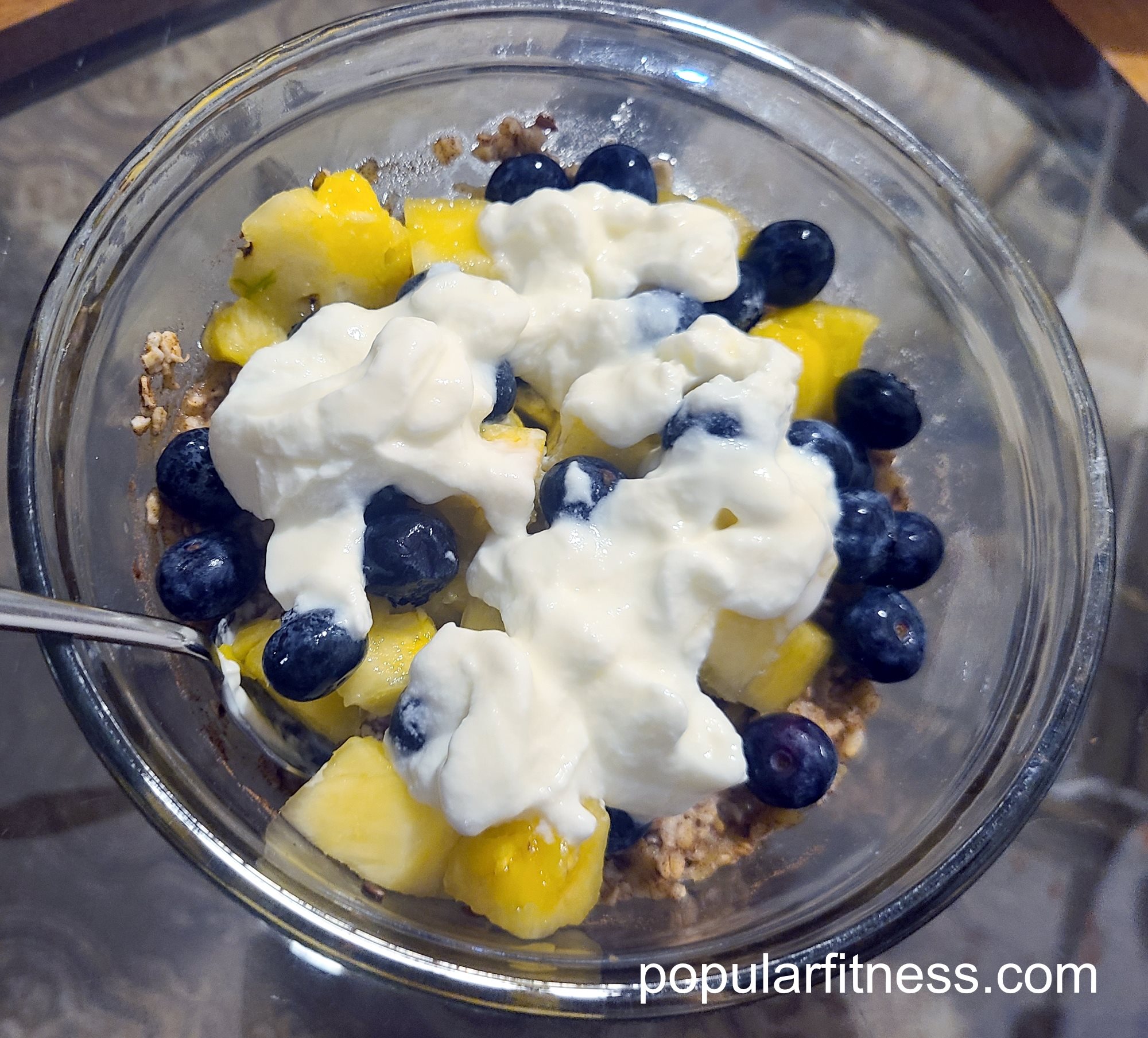 Healthy oatmeal breakfast with 3 fruites,flax seeds, milk, probiotic yoghurt - Photo by popular fitness