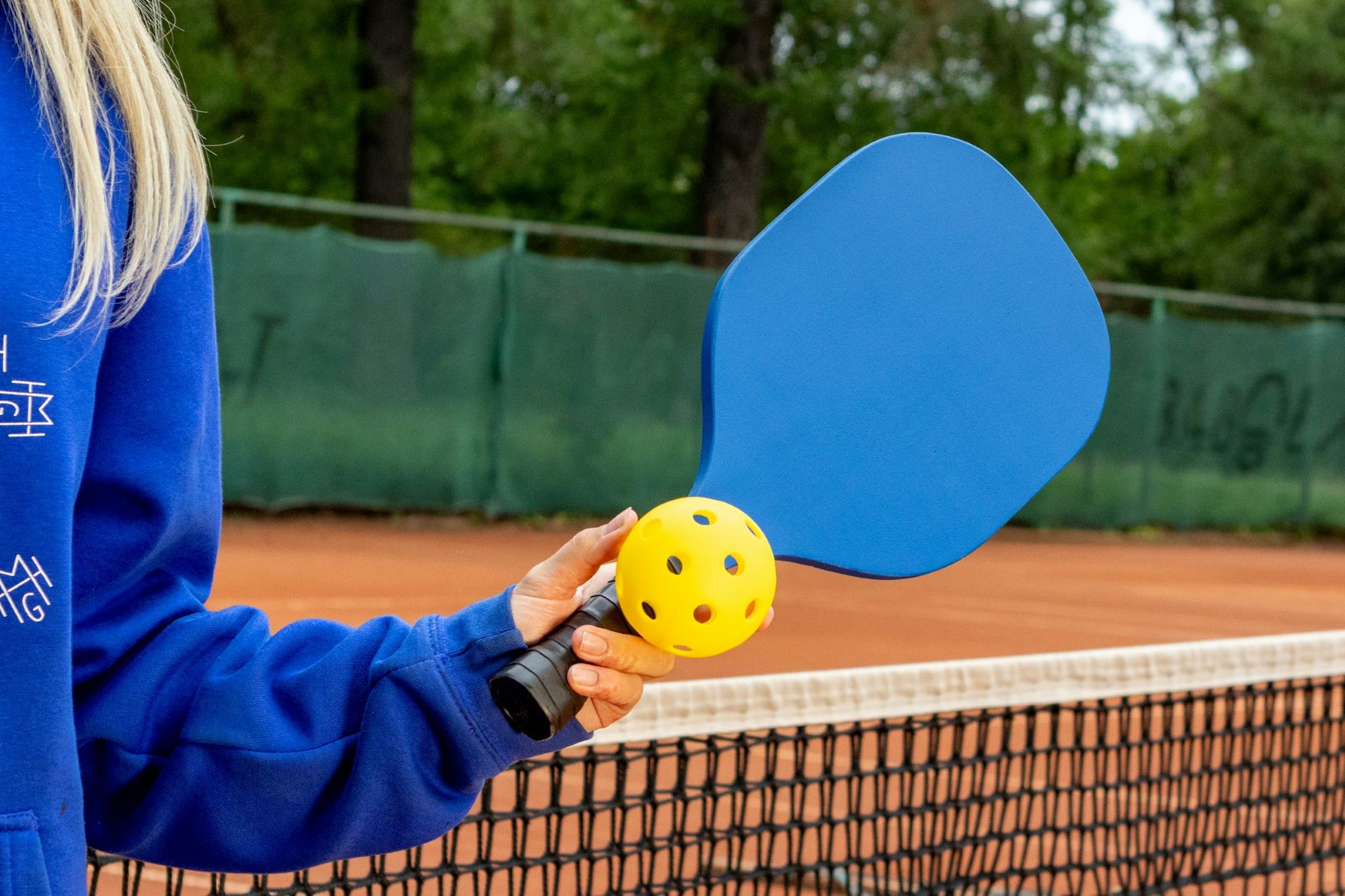 Pickleball player with racket and ball image.