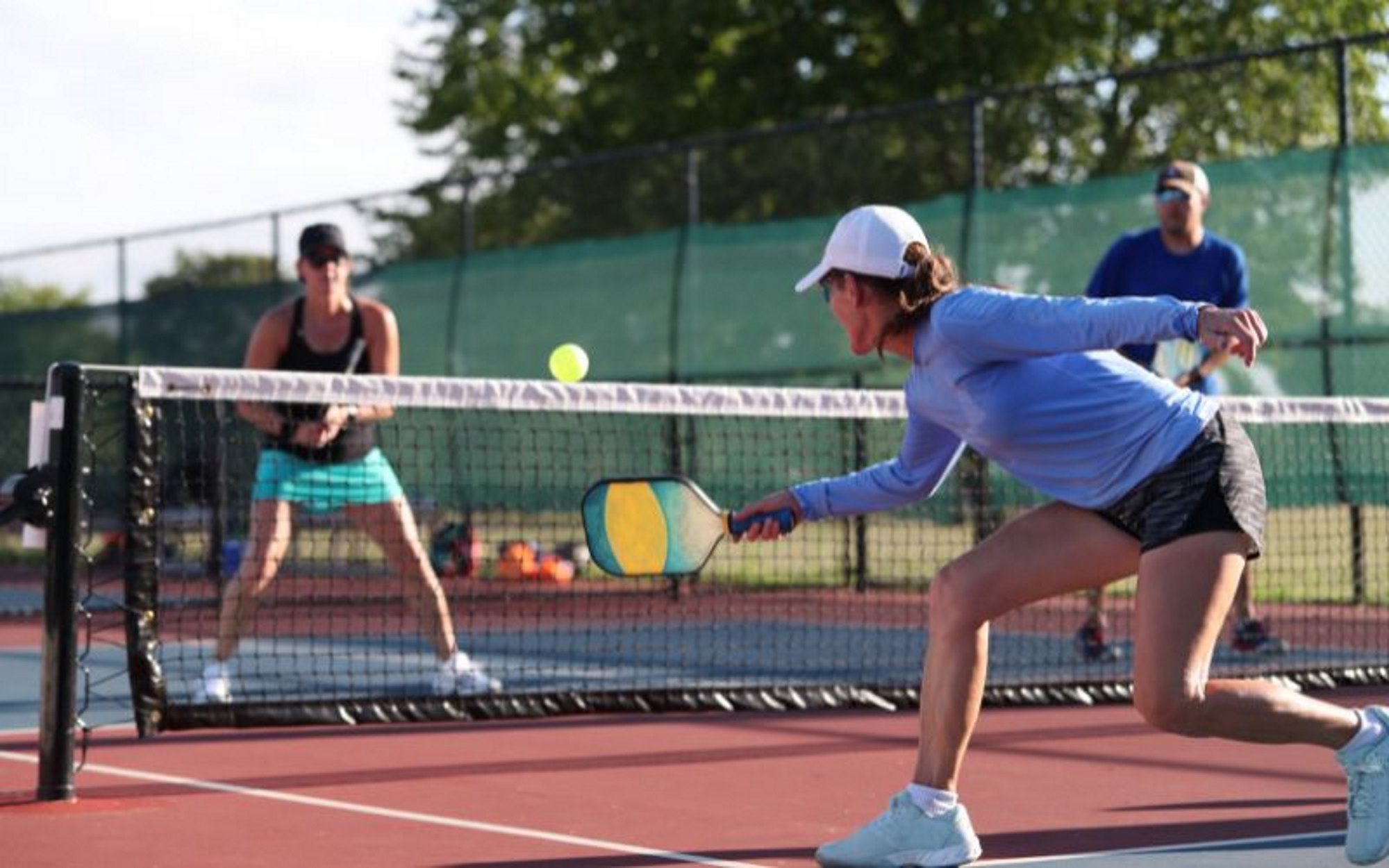 Pickleball players playing sport of pickleball.