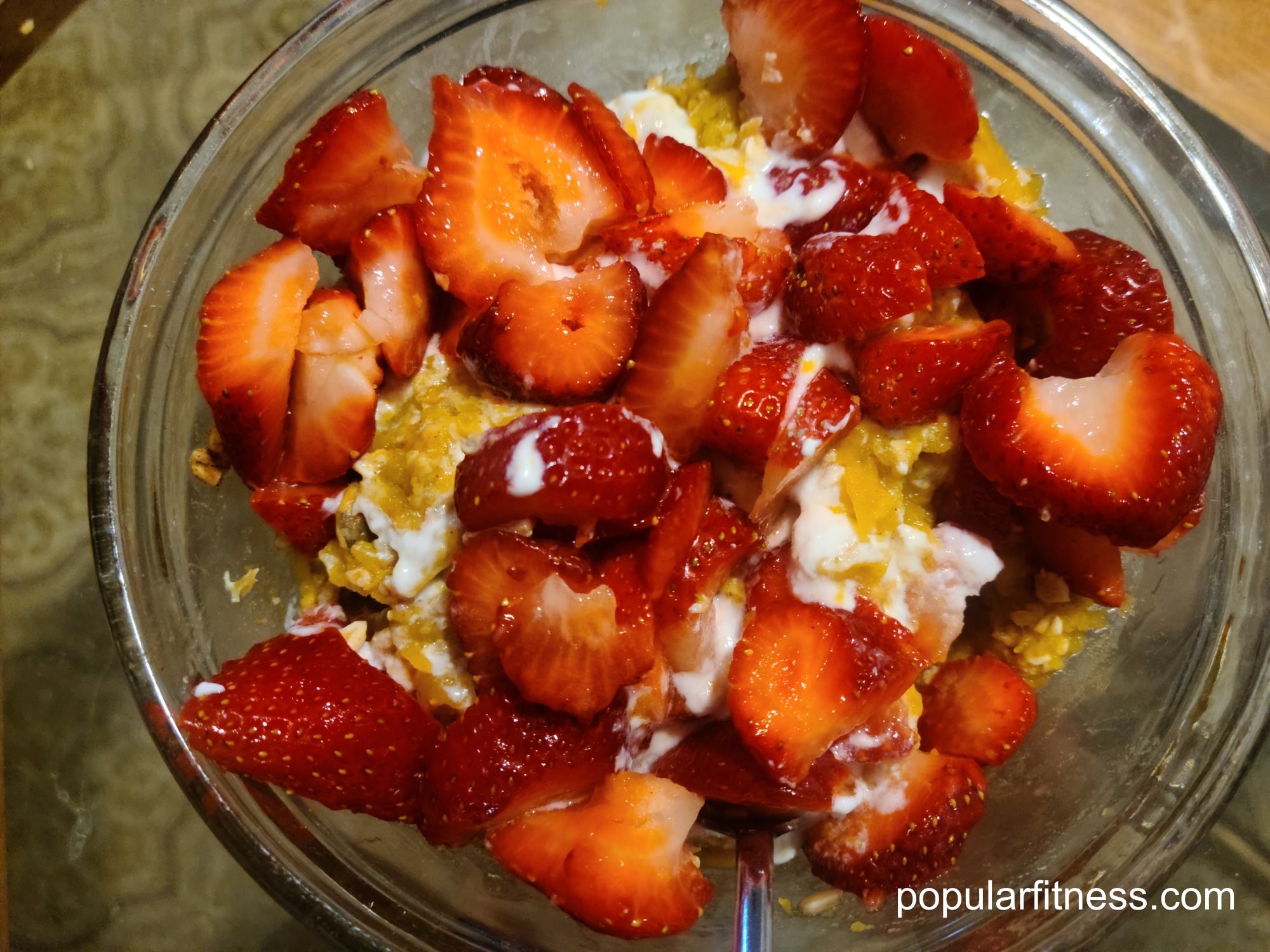 Oatmeal breakfast with pumpkin, strawberries, nuts, seeds, probiotic yogurt, chocolate milk