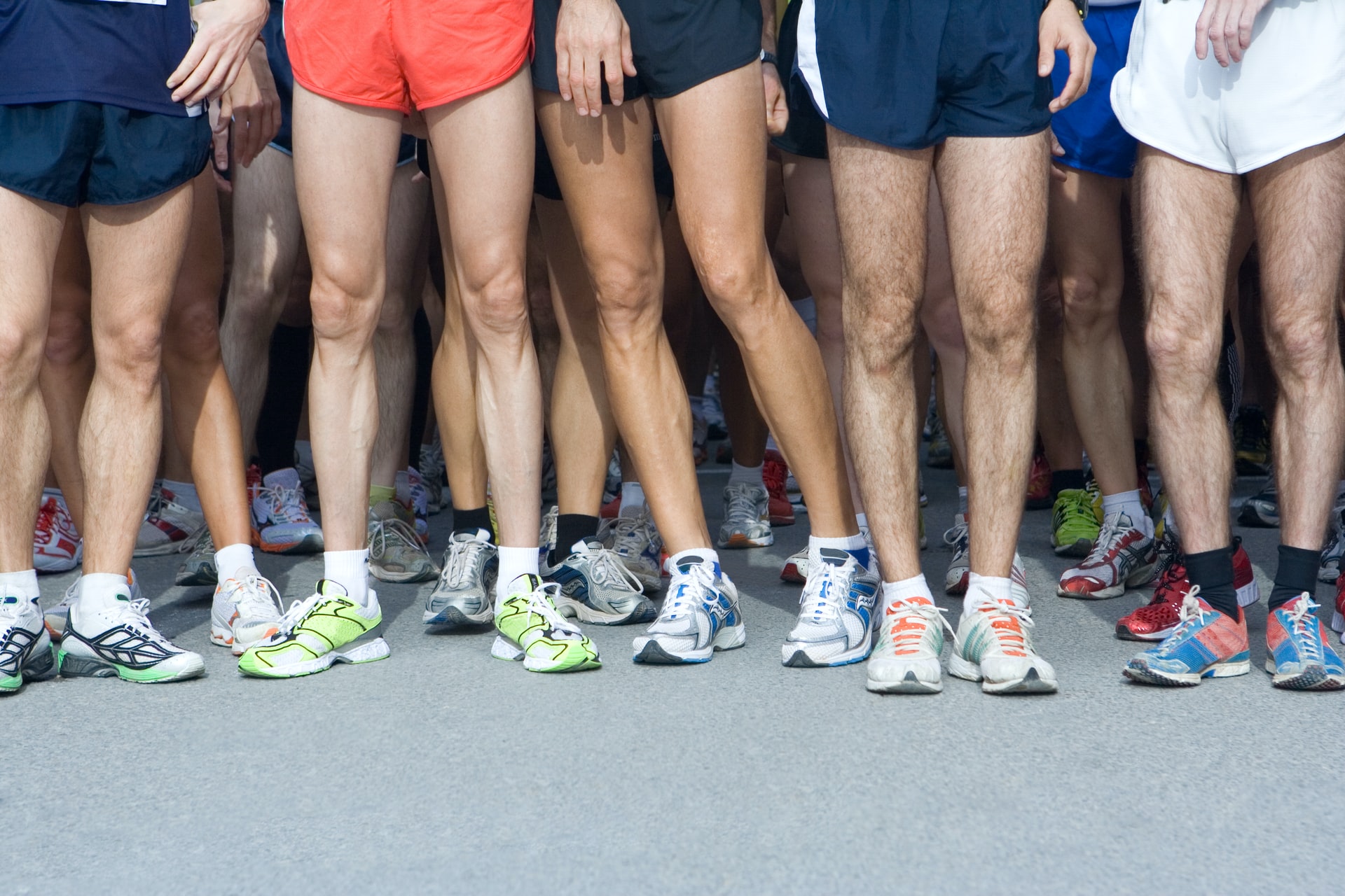 Group of people wearing various running shoes, althletic shoes.