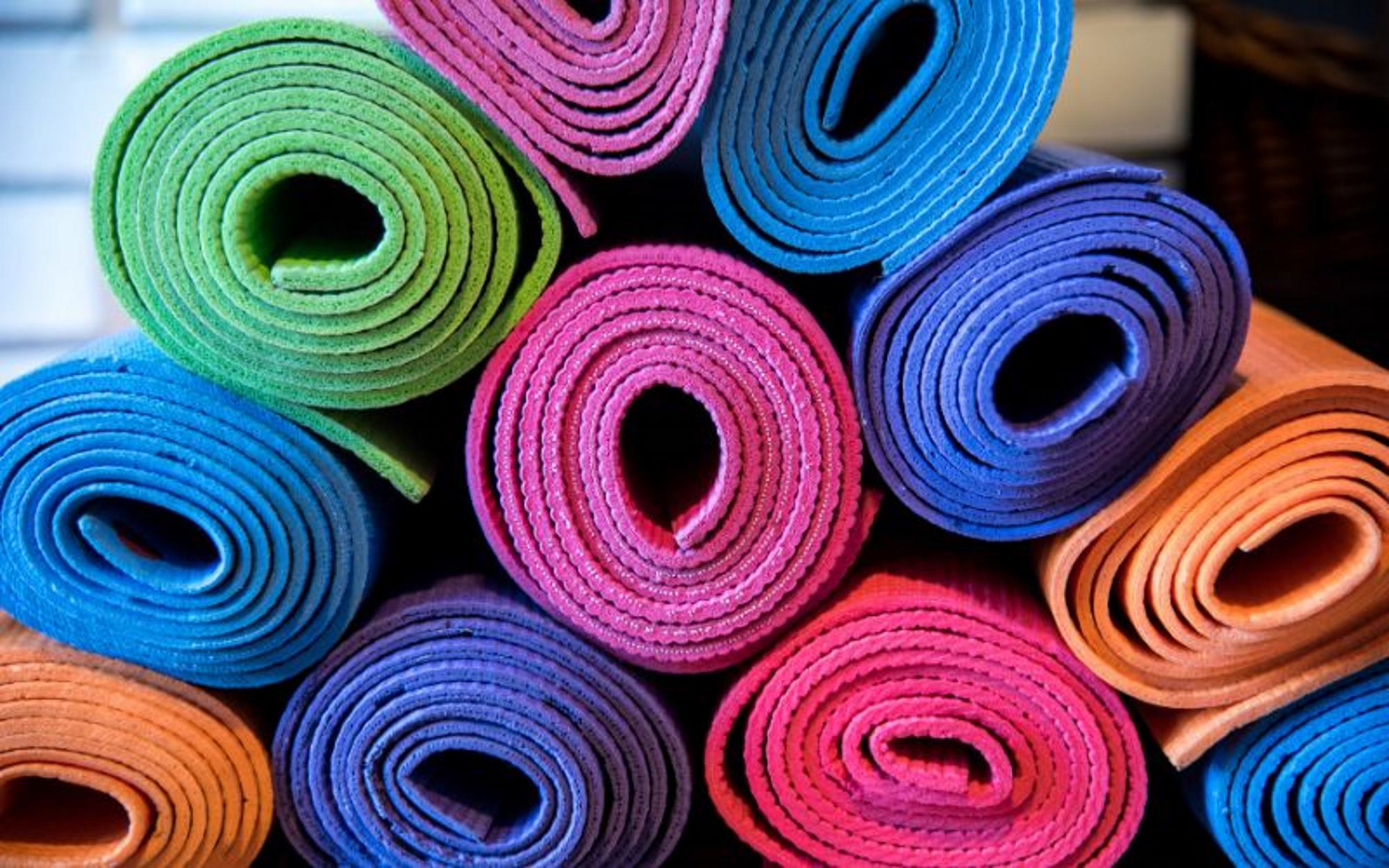 A selection of colorful yoga mats.
