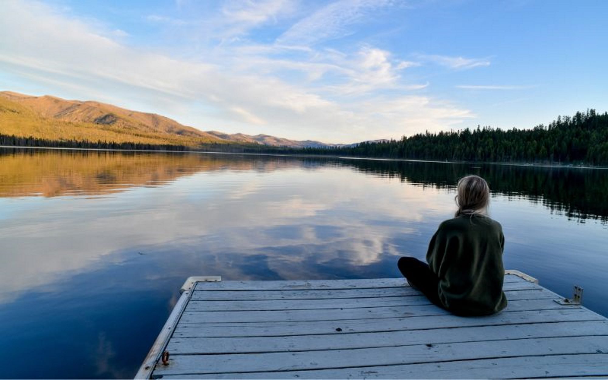 Spending time outdoors by a peaceful quiet lake to improve mental health.
