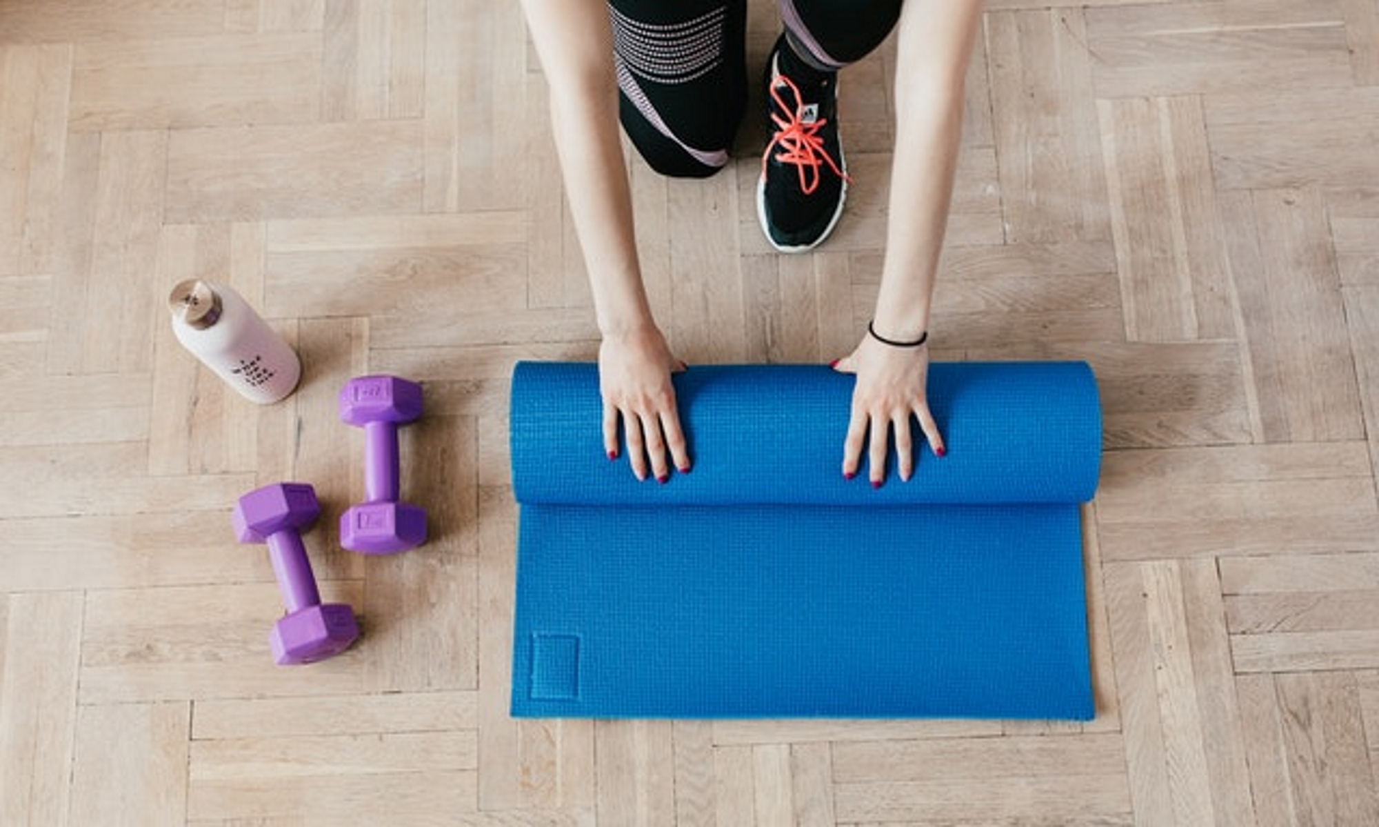 Rolling up her yoga mat after a yoga workout session.