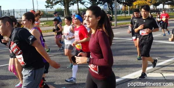 Close-up of a woman running a marathon by popular fitness