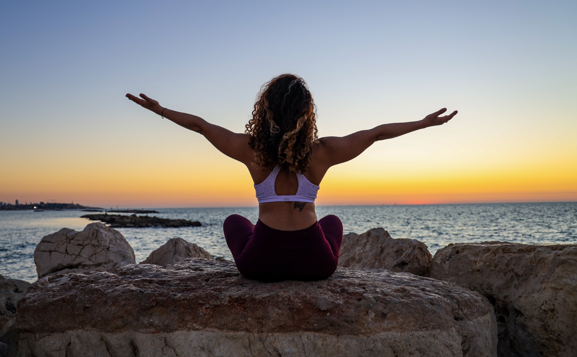 A woman enjoying a beautiful sunset