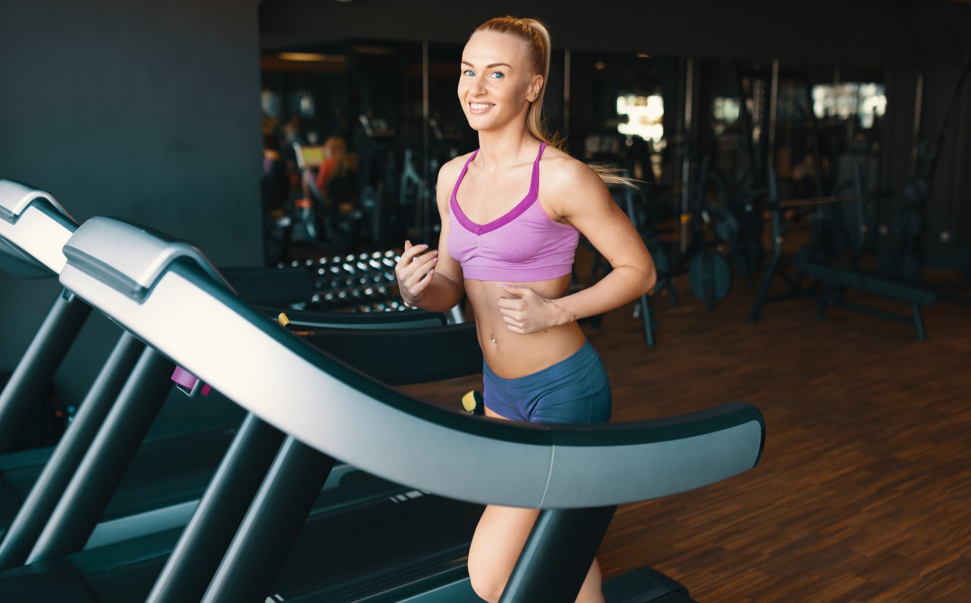 Young blonde woman running on treadmill - freepik.com - by Arthur Hidden