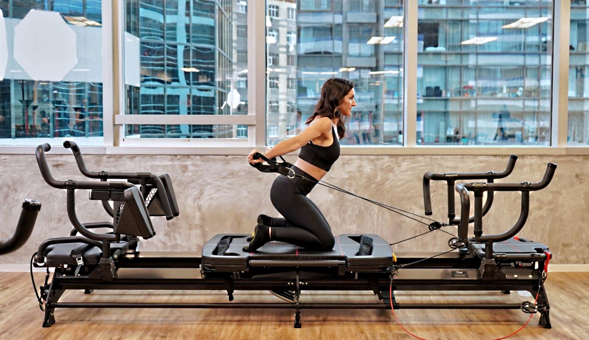 Woman exercising using the Megaformer exercise machine