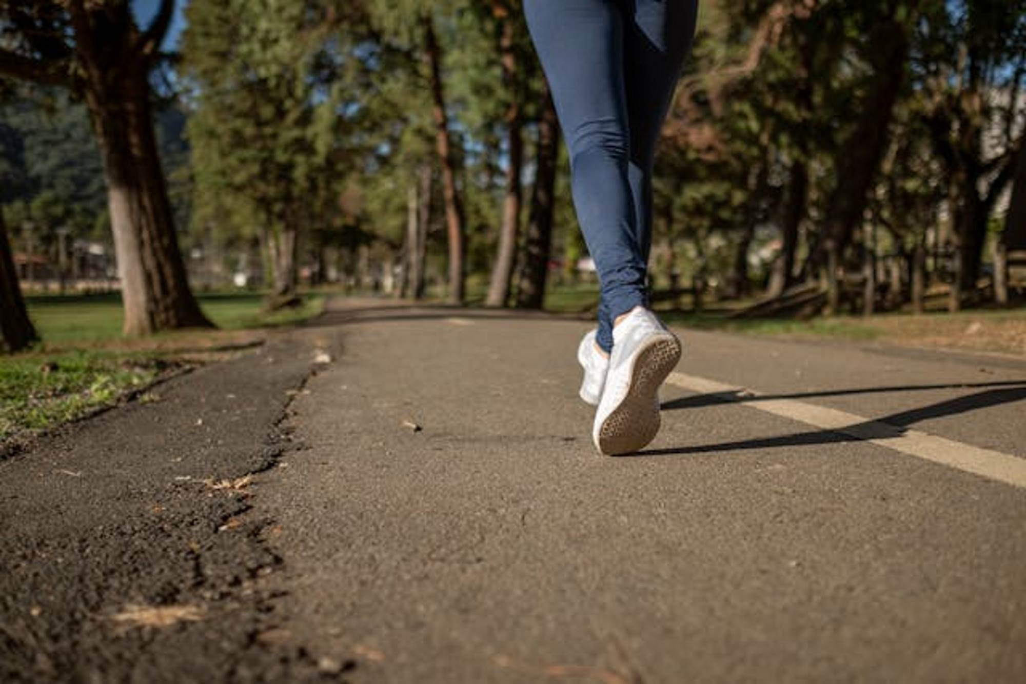 Woman walking to exercise along a path