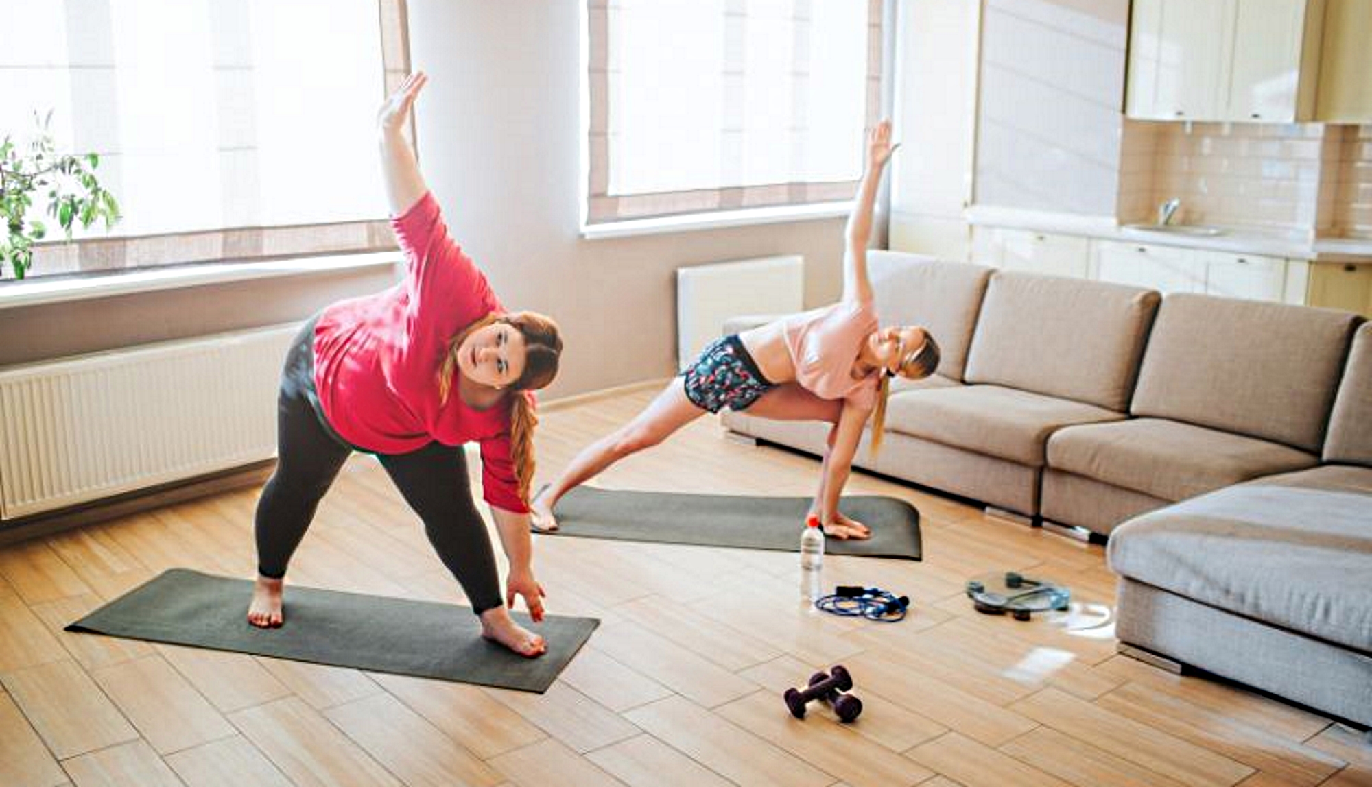 2 women doing yoga exercise